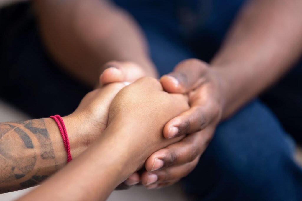 Holding hands support therapy session for teen trauma.